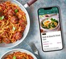 BBC Good Food Premium App next to a pan of spaghetti and meatballs
