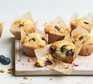 Blueberry muffins on board with berries