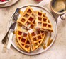 Classic waffles on a plate, cut into triangles