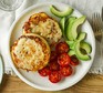 Eggy cheese crumpets with cherry tomatoes and avocados