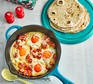 Flatbreads with brunch-style eggs served in a frying pan