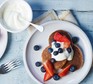 Pancakes on plate with yogurt and fruit