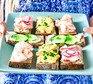 Loaded open sandwiches on a plate