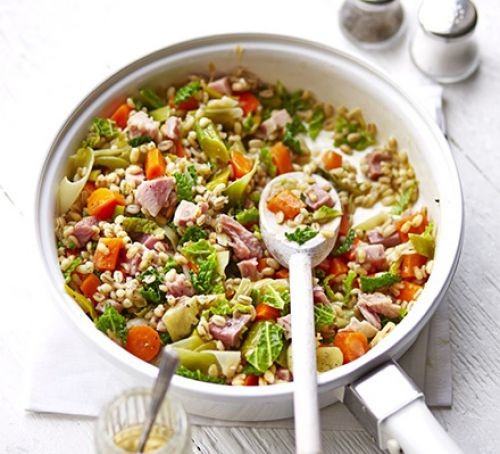 Pearl barley, leek and bacon casserole one-pot with a wooden spoon