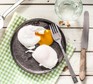 Two poached eggs on a grey plate