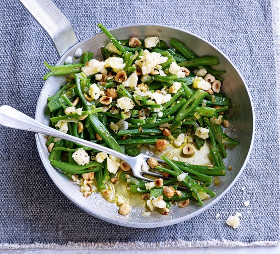 Runner beans in a pan with hazelnuts