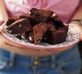 Brownies being held up on a plate