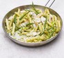 Pesto pasta with chicken and green beans in a wide pan