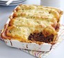 Cottage pie in a rectangular dish with portion taken out