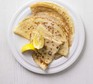 Easy pancakes on a plate with lemon wedges