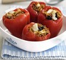 Four vegetarian stuffed peppers in a serving dish