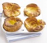 Four Yorkshire puddings in a baking tin