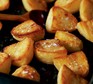 Roast potatoes scattered with salt in a baking tin