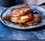 Pancakes with butter and syrup on plate