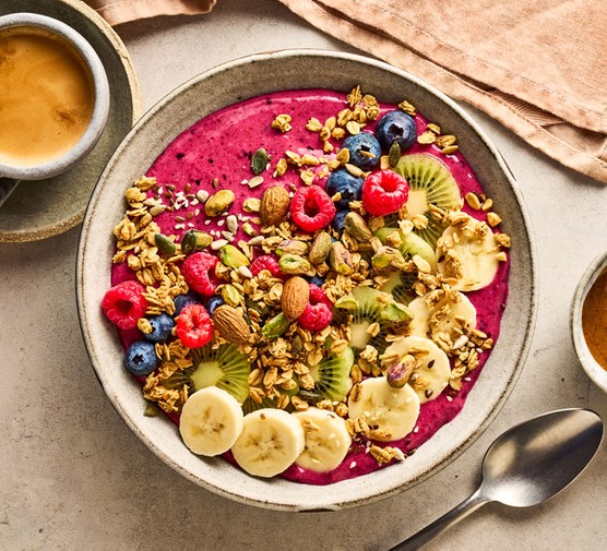 Smoothie bowl, topped with fruit and nuts