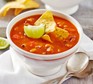 Spicy chilli bean soup topped with tortillas chips and fresh lime