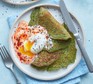 A single serving of spinach pancakes with harissa yogurt & poached eggs